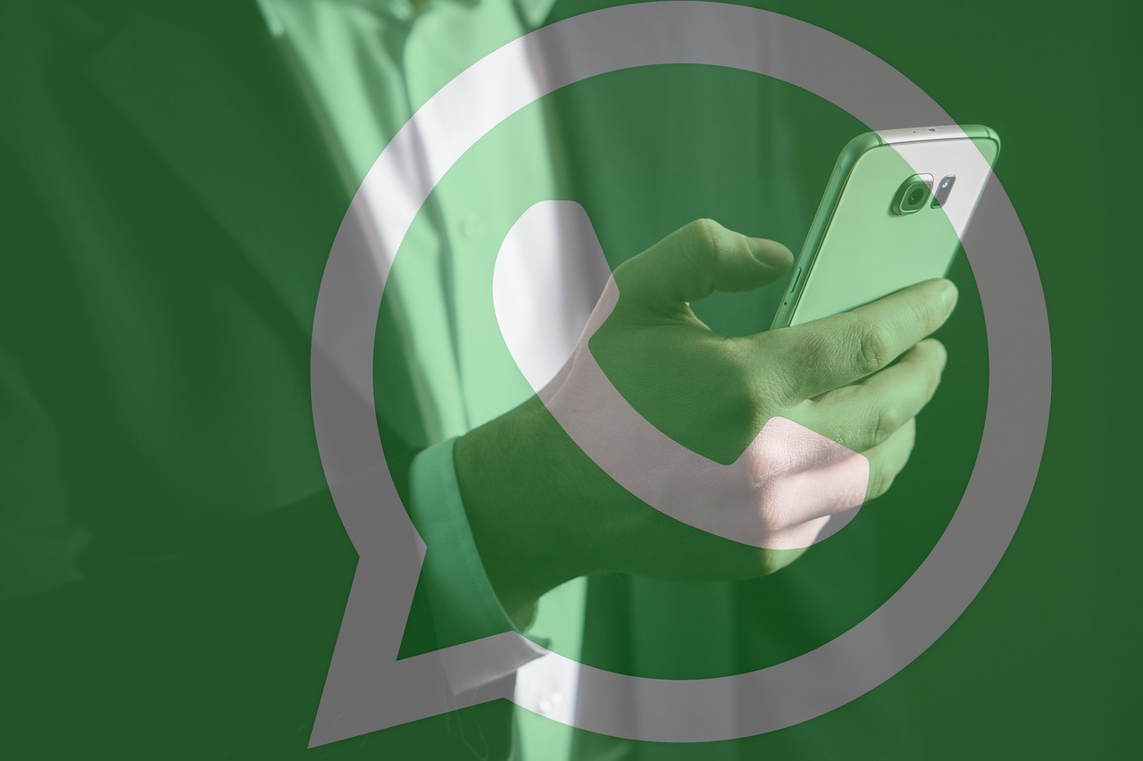 WhatsApp logo overlaying a person texting on a mobile phone, representing the app's new Edit Message and Video Note features